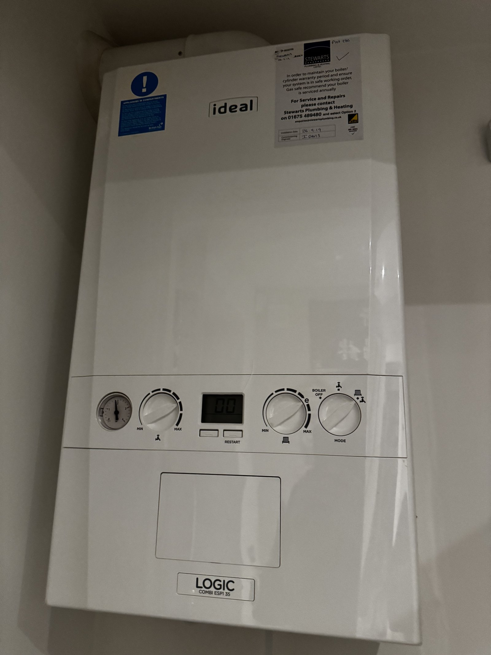 Boiler service engineer working on a combi boiler in Birmingham