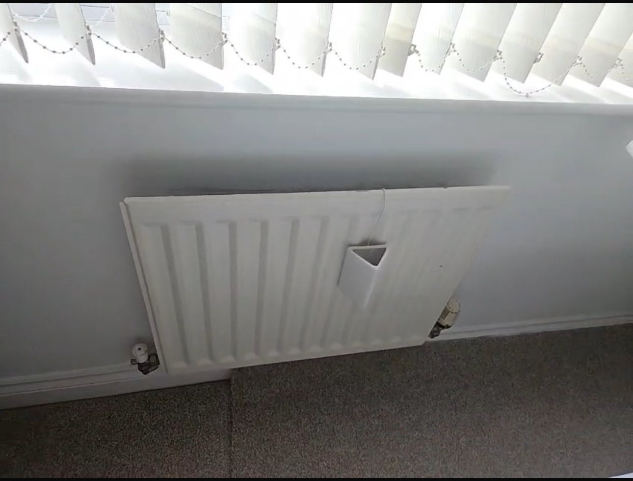 Heated towel radiator installation in a bathroom